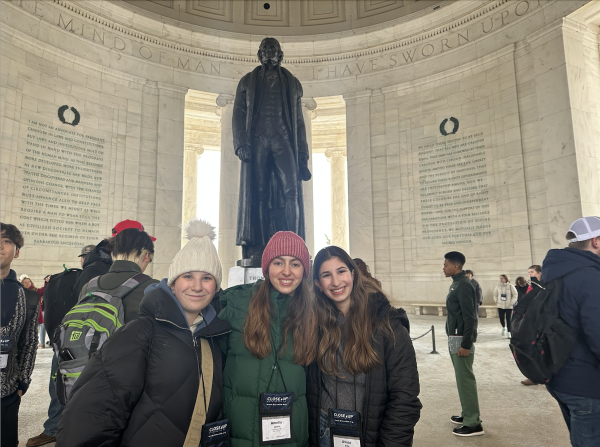 Staning at the foot of the 19-foot bronze statue of Jefferson, juniors Dasha Arnold, Amelia Lewis and Oliva Eres pose for a photo at the Jefferson Memorial. (Photo courtesy of Amelia Lewis)